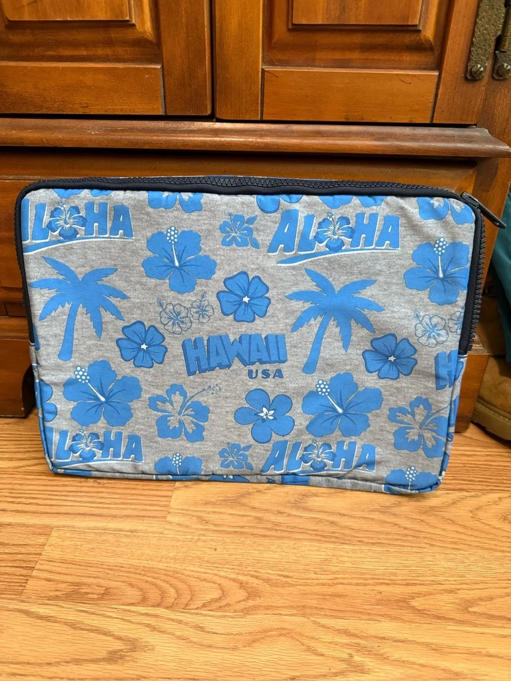 LeSportsac brand travel pouch or laptop case featuring a blue and grey hibiscus